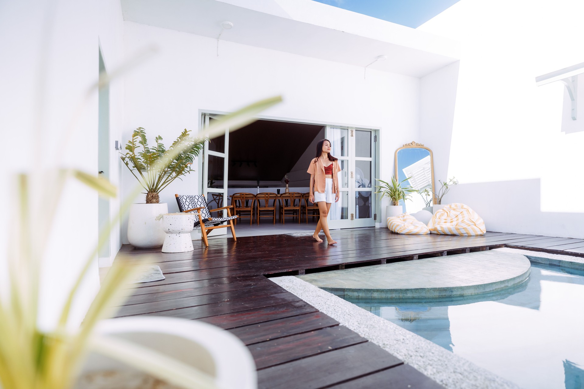Beautiful Asian Woman Standing at the Edge of Pool in A Luxury Beach Villa